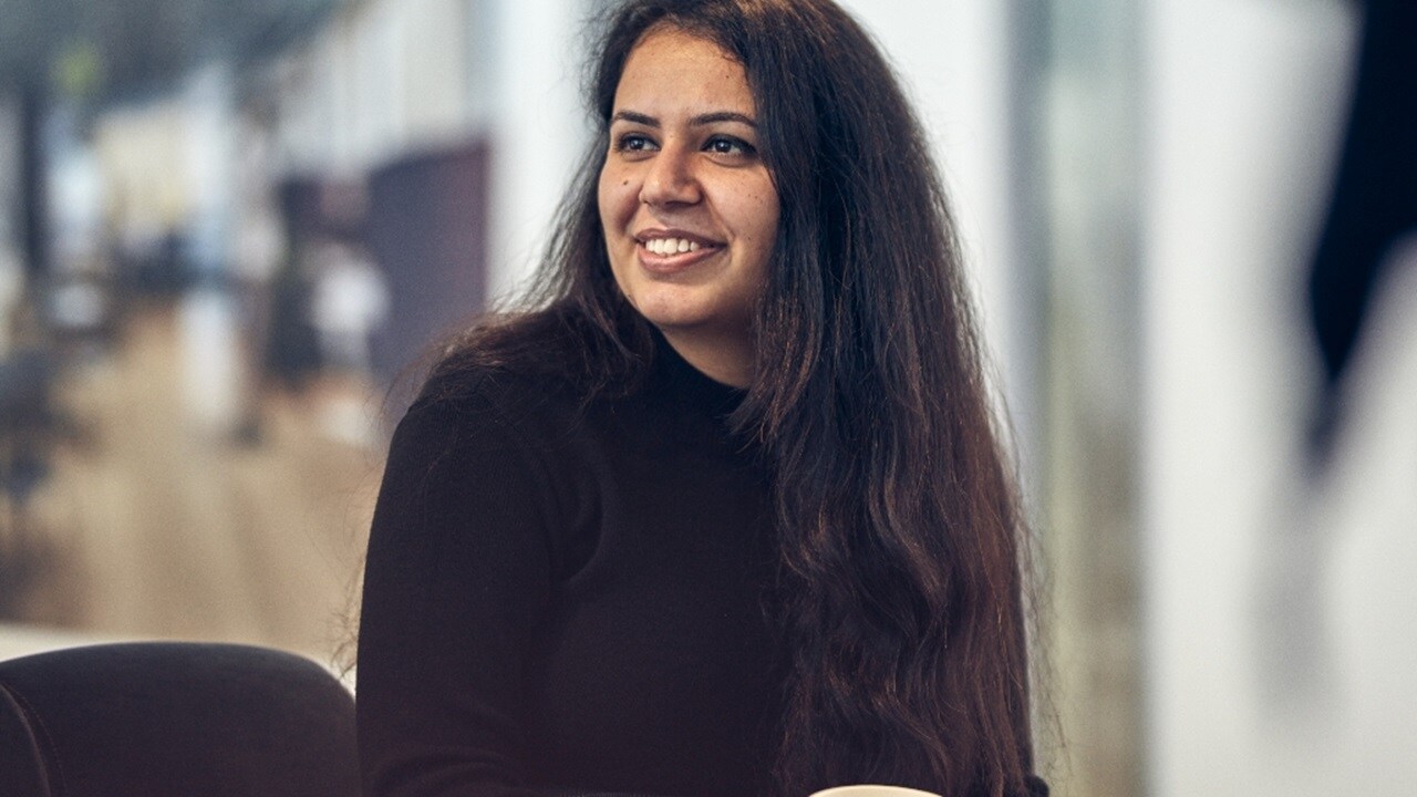 Male smiling at his work station