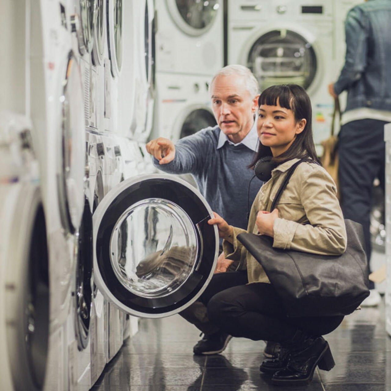 Customers checking out washing machine in a showroom