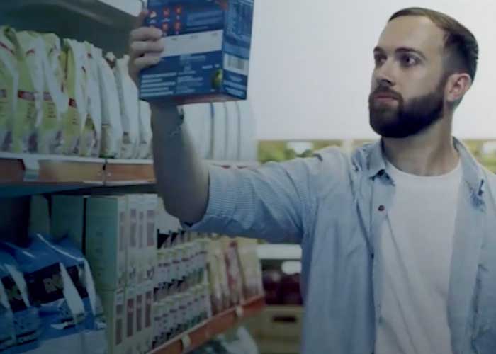 A make customer checking out products at a retail supermarket