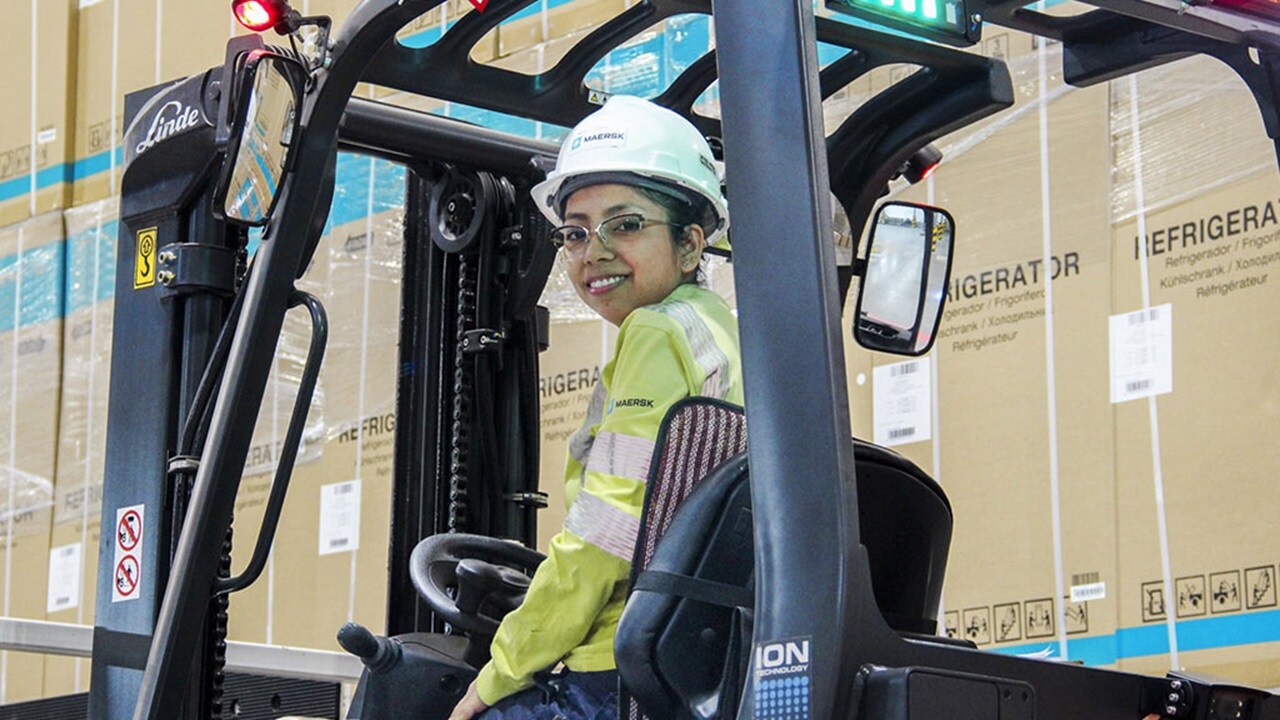 Warehouse employee driving forklift