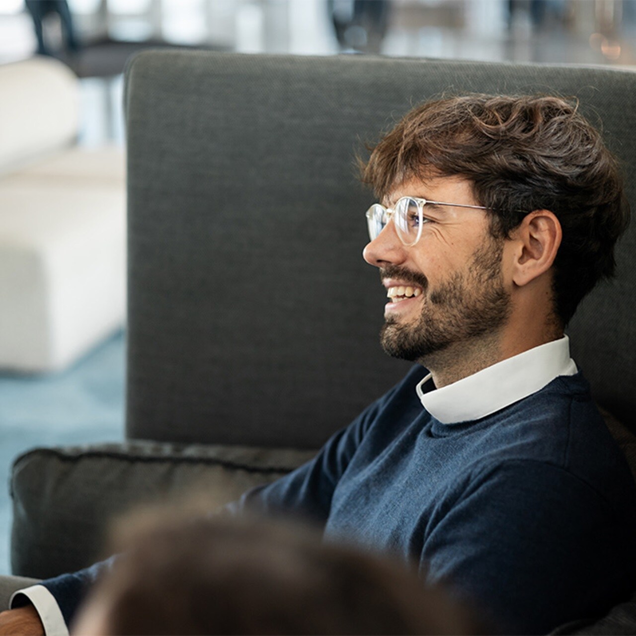 Employee smiling and wearing glasses
