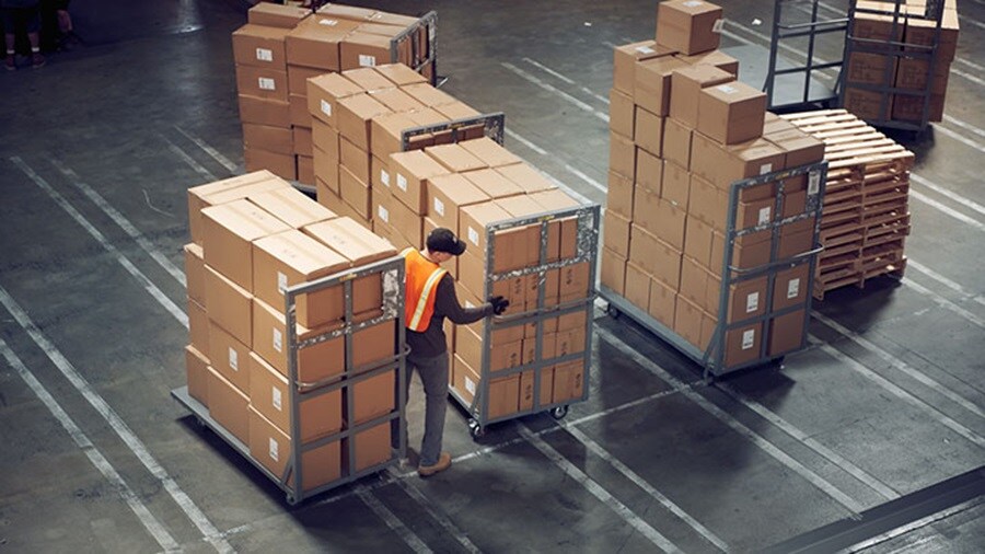 Worker organising packages at a warehouse