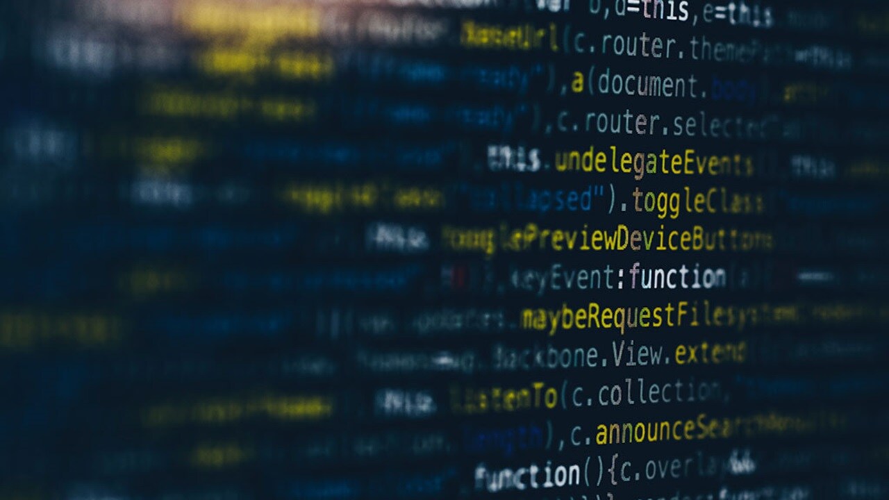 A closeup of a computer screen showing various, mostly illegible, words that make up code