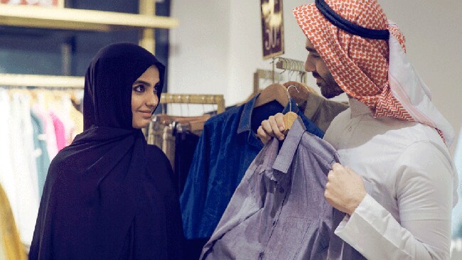Arab man and woman shopping for clothes