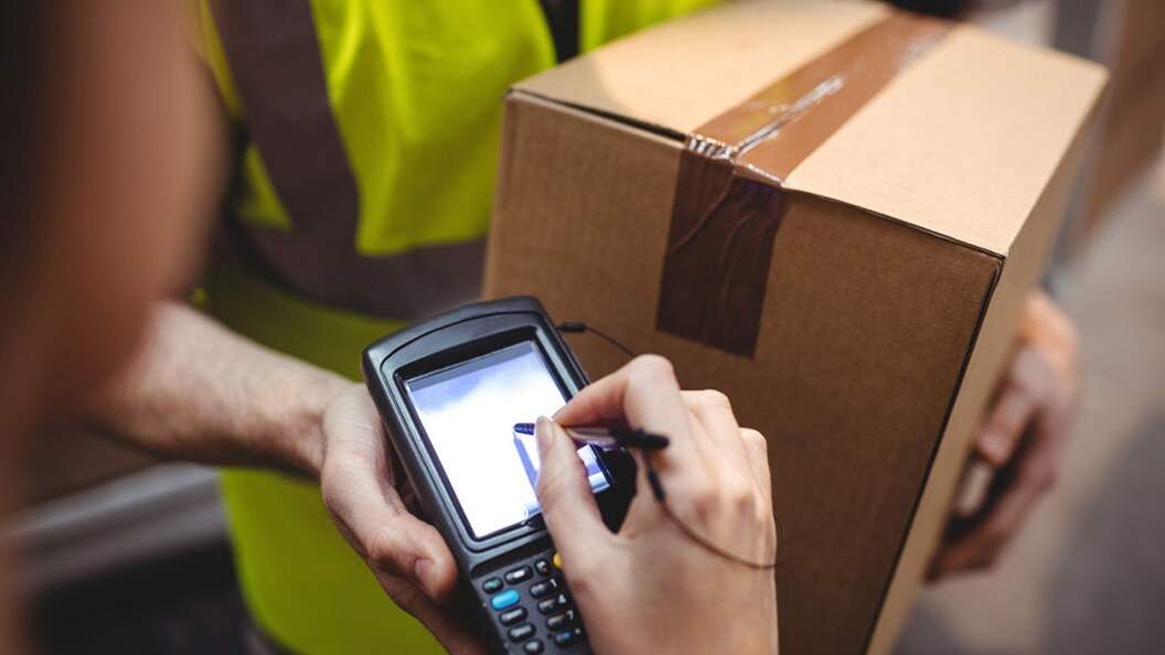 Customer signing delivery man’s device for delivering order