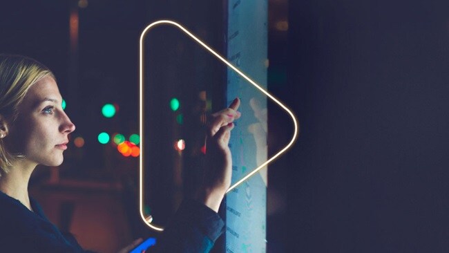 Women touching LED screen