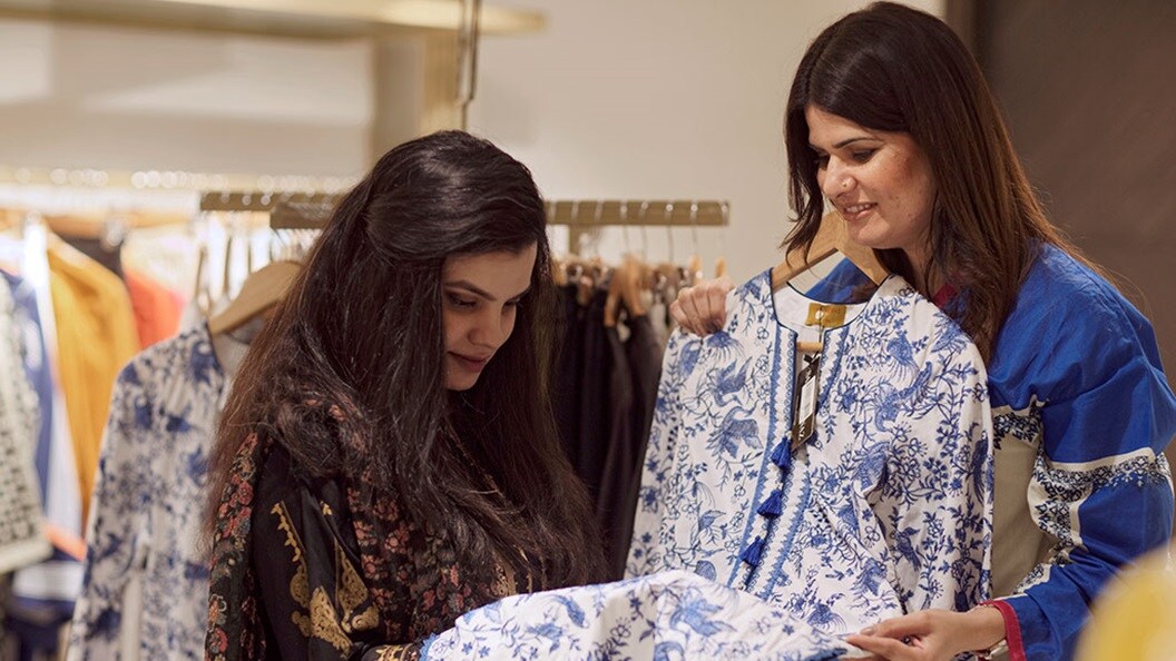 Two women shopping clothes