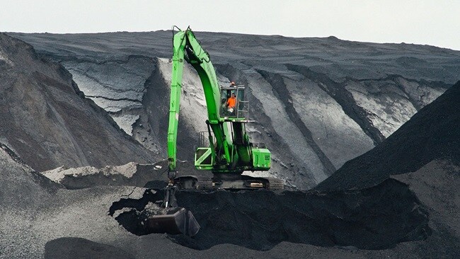 Big green excavator working on a mountain symbolising the special cargo