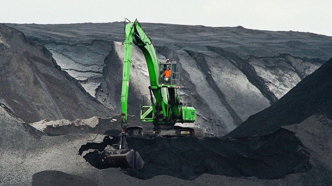 Big green excavator working on a mountain symbolising the special cargo