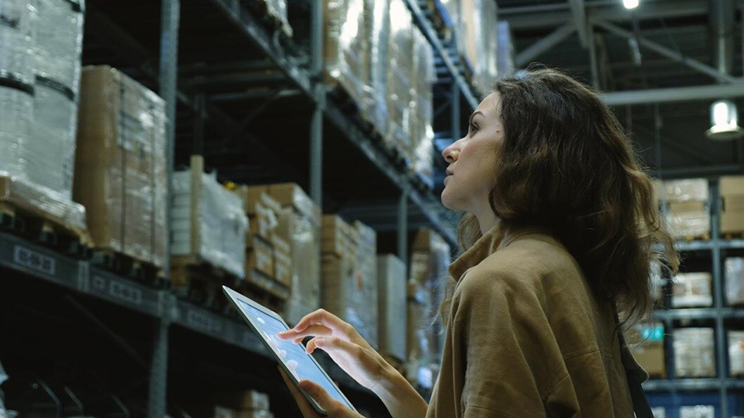 Woman checking stock levels in warehouse