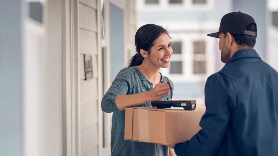Woman receiving package from delivery man