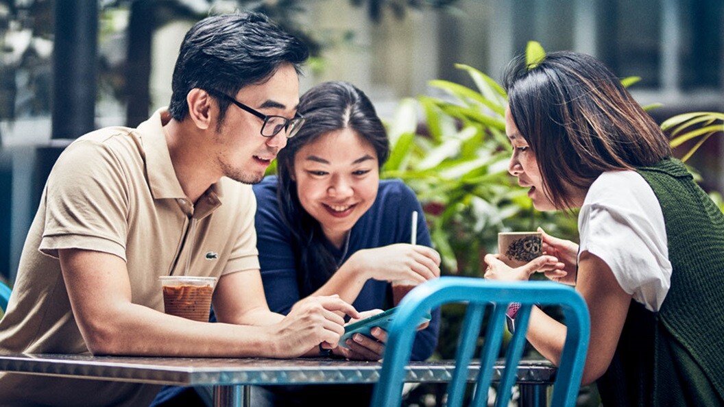 Human hands typing on a laptop keyboard