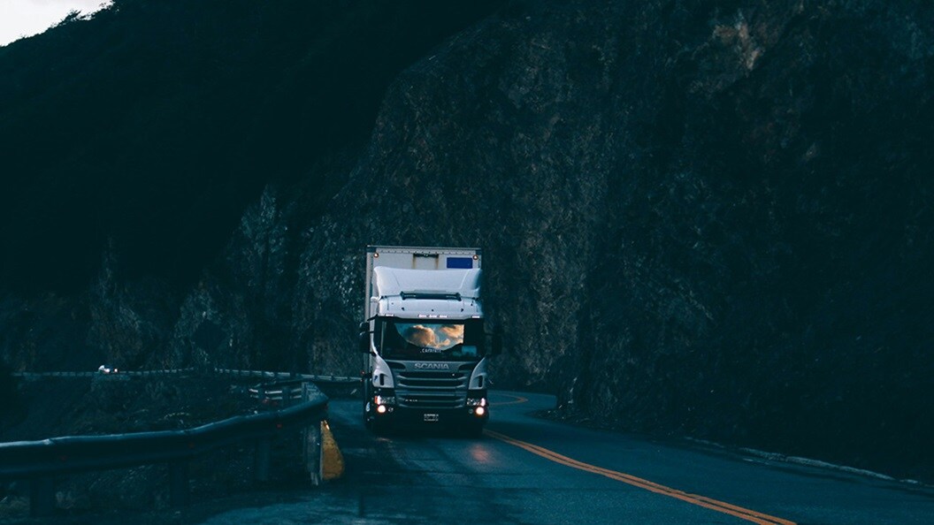 Trailer truck passing on road near rail guard