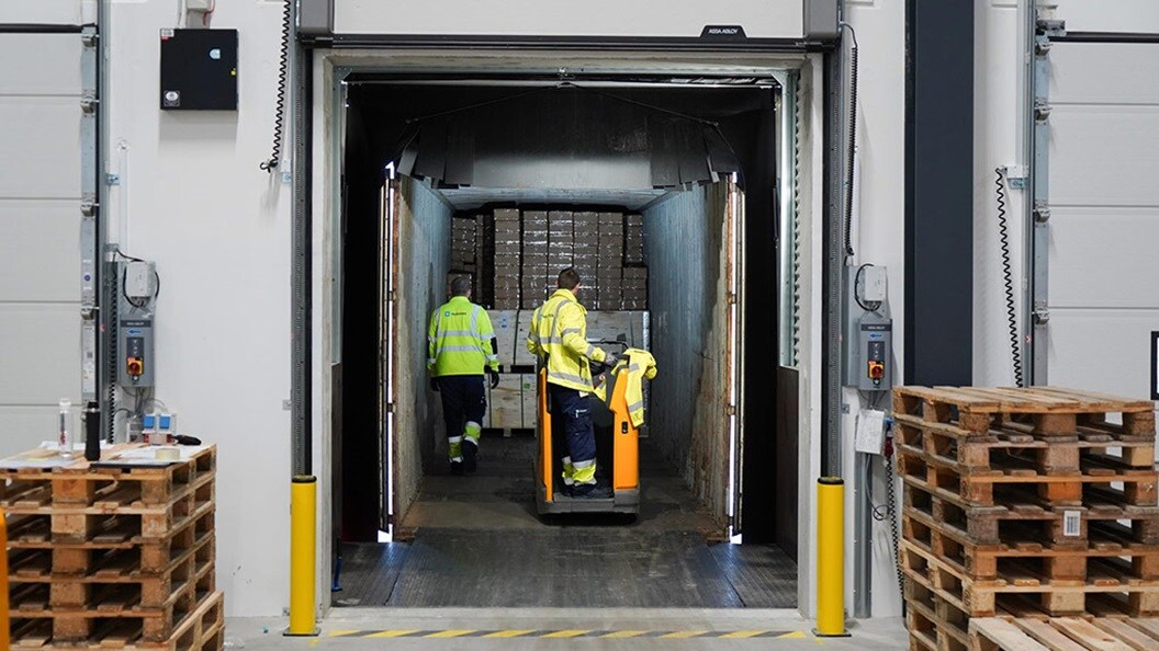 Warehouse employees moving goods to container