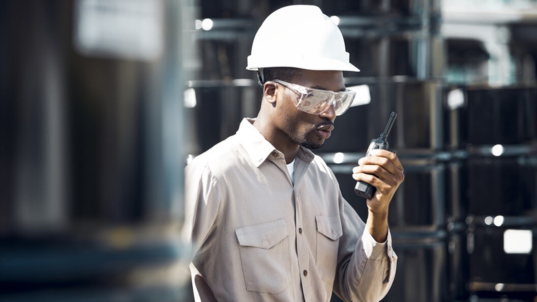Security personnel with white helmet and goggles at warehouse