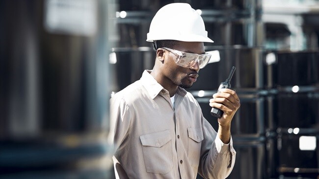 Security personnel with white helmet and goggles at warehouse