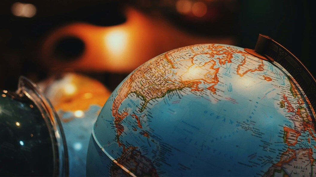 Close-up of a world globe highlighting North America and Europe, representing global trade routes and international supply chain dynamics in 2025.