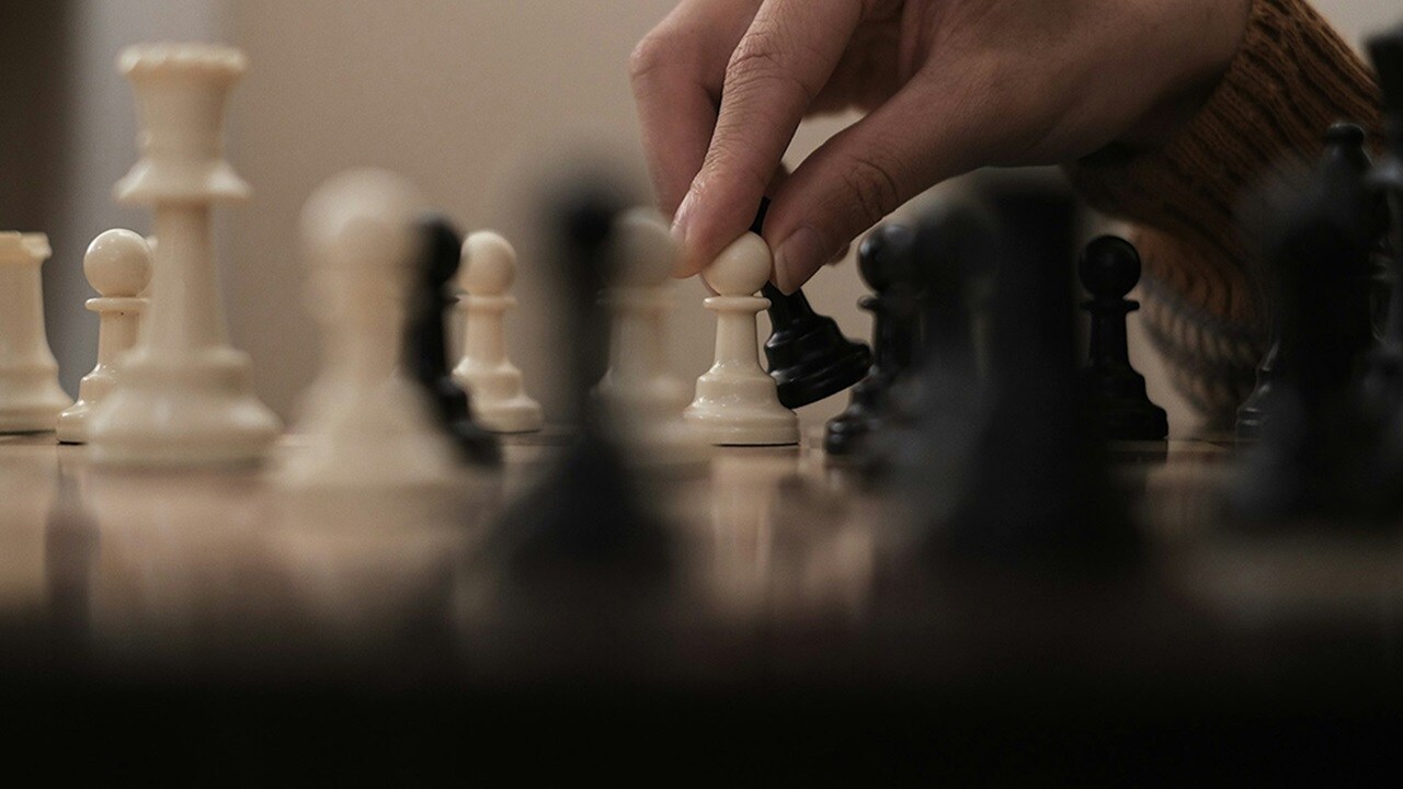 person playing a game of chess
