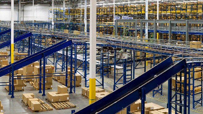 Warehouse interior filled with boxes and conveyor belt system