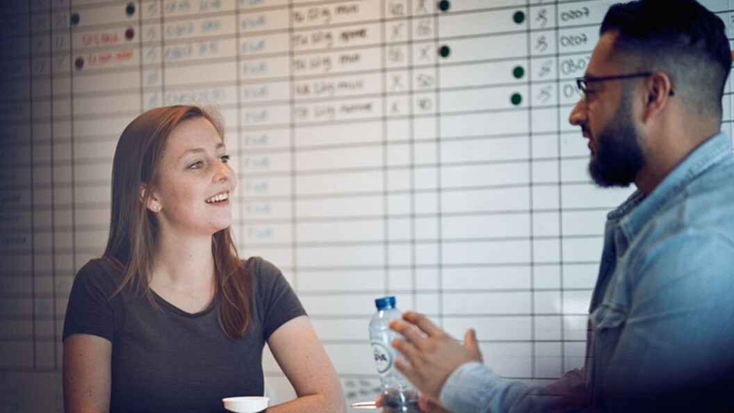 Two colleagues in discussion symbolising the chemical industry’s road to reducing supply chain emissions