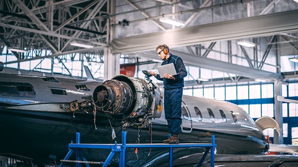 Aircraft engineer standing on a raised work platform