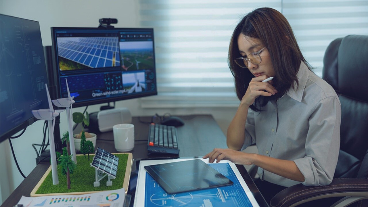 Woman working on tabloid in office