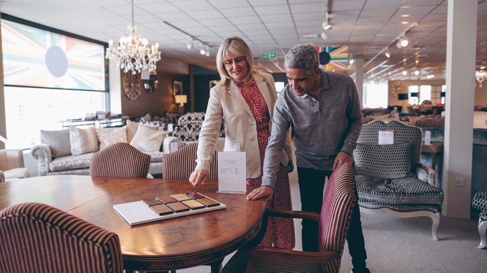 Male and female looking at furniture in a store