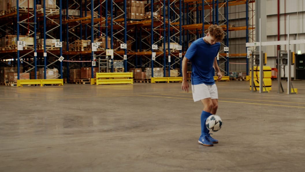 A male juggling with a football