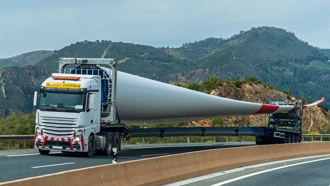 Truck transporting a large wind turbine blade.