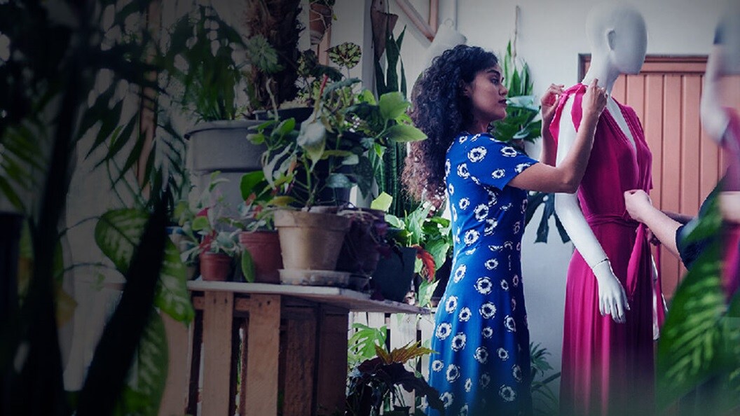 Women dressing the mannequin