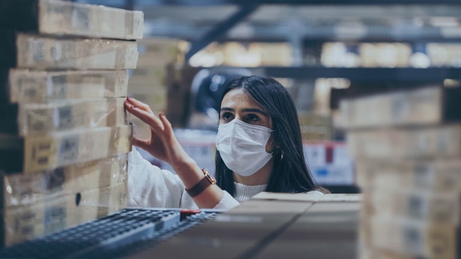 Woman looking for a shipment in the warehouse