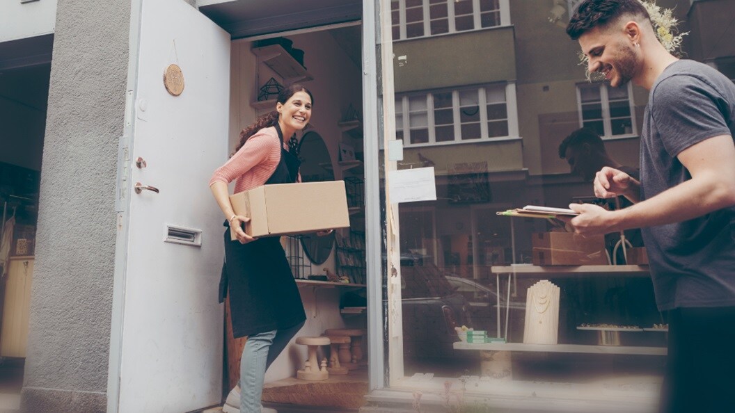 Shipment being delivered by a man to a woman