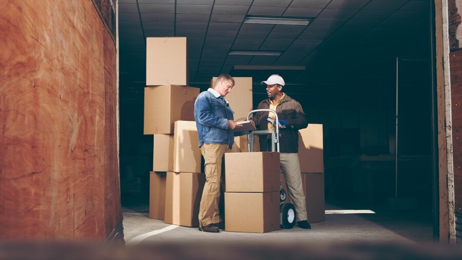 Two men unloading boxes