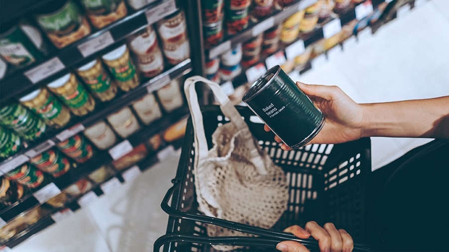 Woman holding a canned food at a grocery store