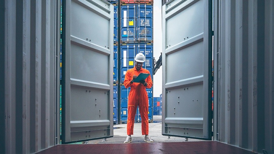 A man standing outside a container