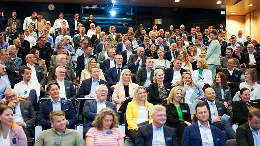 Group of people listening to a speaker at an event