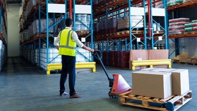 Man with box of container at warehouse