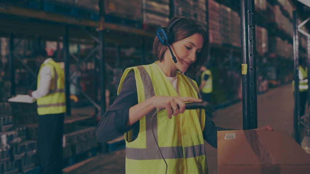 Female logging a shipment at the warehouse