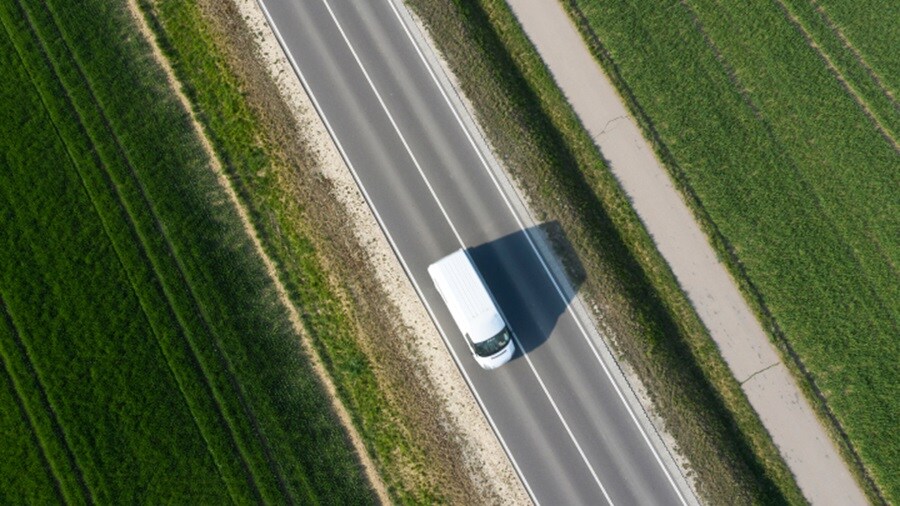 White truck driving along the road 