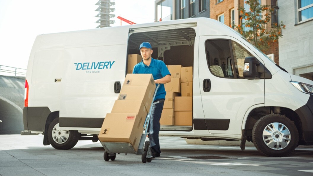 Male making deliveries with shipments in a truck