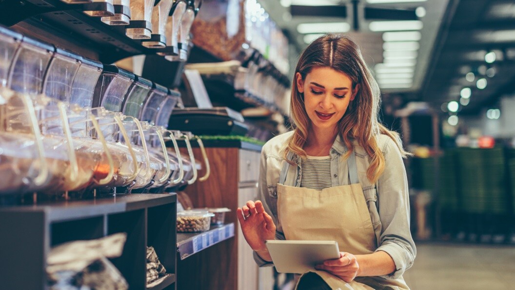 Female looking at a tablet in a grocery store