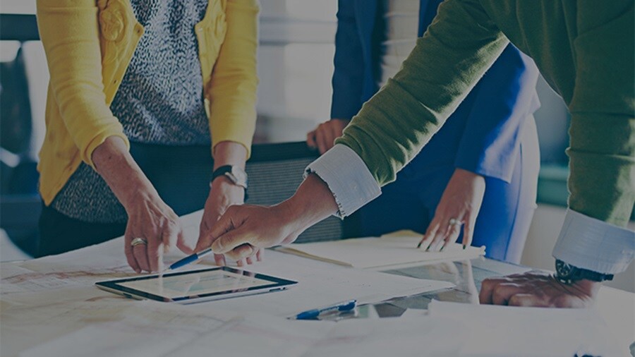 3 sets of hands working on a table
