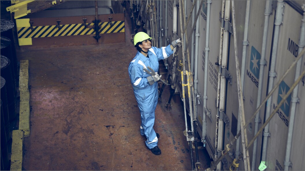 Male with protective gear outside a container