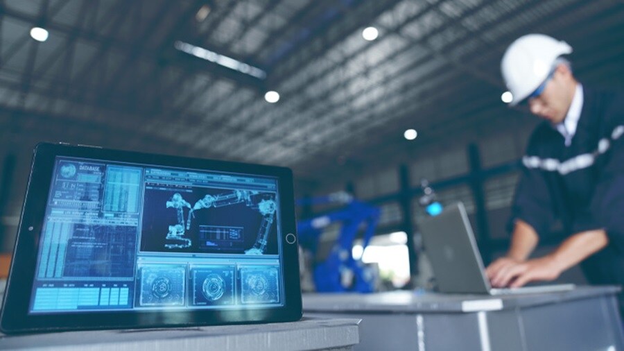 Tab screen showing statistical data with a male working in the background