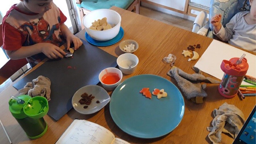 Maersk employee working from home with children due to COVID-19.