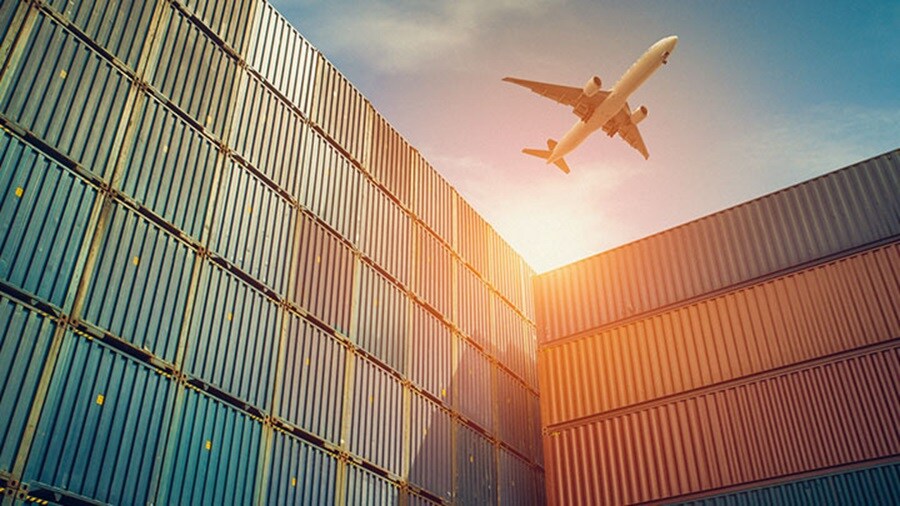 Plane flies over containers