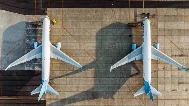 Overview shot of two plane parked on an airstrip