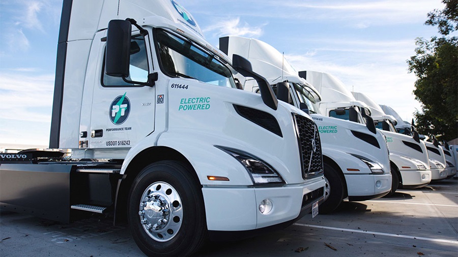 Electric trucks parked at a Maersk facility