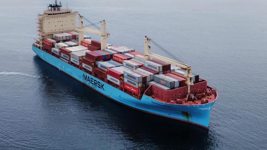 A view of Maersk's largest container ship, illustrating its enormous size and advanced engineering at the harbor.