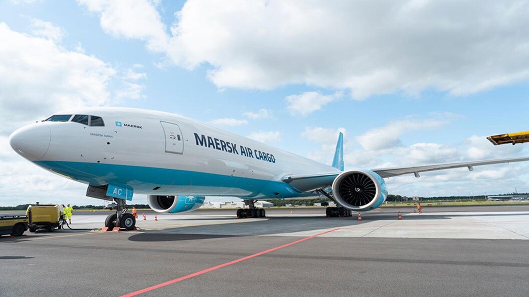 Maersk Air Cargo plane on a tarmac waiting for cargo loading.